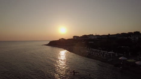 Aerial-scene-of-resort-and-sea-at-sunset-Trikorfo-Beach-Greece