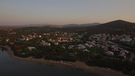 Cottages-on-sea-shore-of-Trikorfo-Beach-in-Greece-aerial