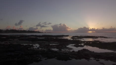 Black-stones-and-coast-in-Mauritius-at-sunset-aerial-view