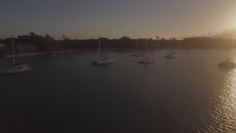 Flying-over-yachts-along-the-coast-at-sunset