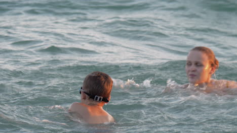 Boy-having-fun-in-water-with-mum