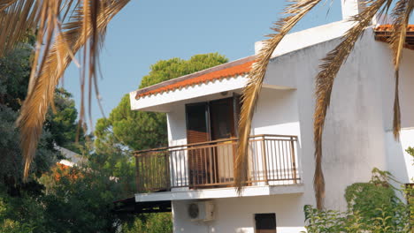 House-with-balcony-among-green-trees