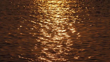Golden-sun-path-on-dark-sea-water