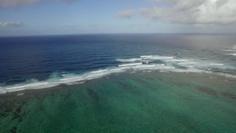 Aerial-view-of-water-line-of-seas-that-do-not-mix-against-blue-sky-with-clouds-Mauritius-Island