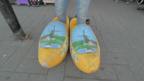 Woman-trying-on-giant-Dutch-clogs-in-the-street