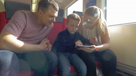 View-of-happy-family-in-the-railway-trip-using-smartphone-Prague-Czech-Republic