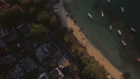 Flying-over-housing-on-the-coast-and-boats-in-lagoon