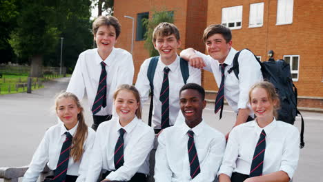Portrait-Of-Teenage-Students-In-Uniform-Outside-School-Buildings