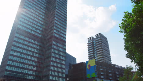 LONDON---MAY,-2017:-Traffic-passing-modern-high-rise-buildings-against-blue-sky,-London