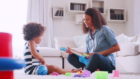 Young-black-girl-and-mum-playing-instruments-in-sitting-room