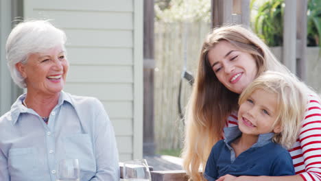 Multi-Generation-Family-Enjoy-Outdoor-Drinks-At-Home