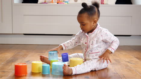 Female-Toddler-At-Home-Playing-With-Stacking-Plastic-Toy