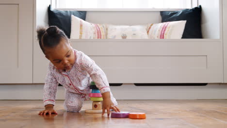Female-Toddler-At-Home-Playing-With-Wooden-Stacking-Toy