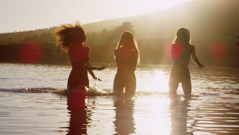 Three-female-friends-on-vacation-having-fun-in-a-lake