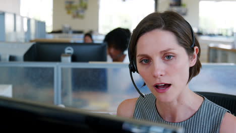 Young-white-woman-working-at-a-call-centre,-close-up