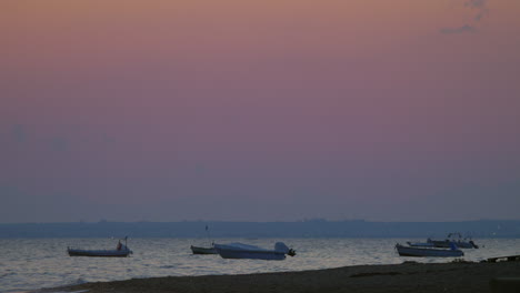 Moored-motor-boats-rocking-on-sea-waves-in-the-dusk