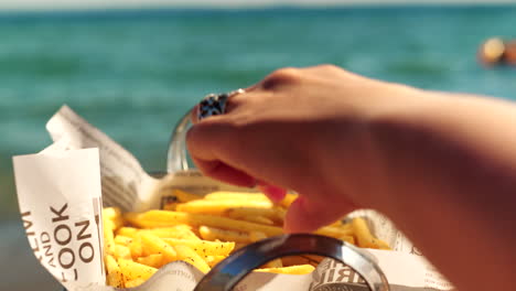 Eating-tasty-crunchy-French-fries-at-the-beach