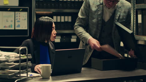 Forensic-team-examining-clues-and-evidence-stored-in-a-case-box