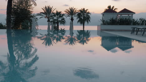 Steadicam-shot-of-an-empty-swimming-pool-and-the-evening-scenery