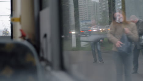 Bus-leaving-transport-stop-window-view