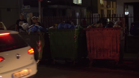 City-street-with-full-waste-containers-night-view