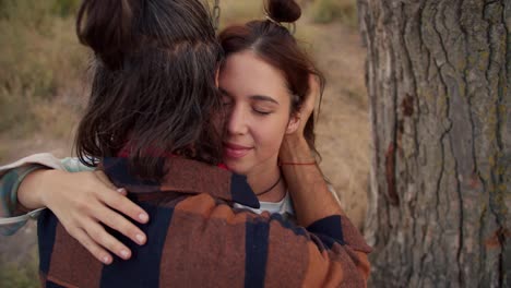 Close-up-shooting:-A-brunette-boy-and-a-brunette-girl-are-swinging-on-a-swing.-Couple-in-love-hugging.-Rest-in-the-country-house