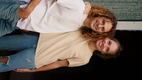 Vertical-portrait-video:-A-girl-in-a-t-shirt-and-jeans-hugs-her-curly-haired-boyfriend-in-glasses.-Rest-in-the-country-house