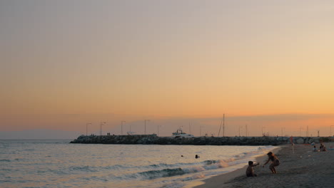 Children-playing-on-the-beach-Resort-scene-at-sunset