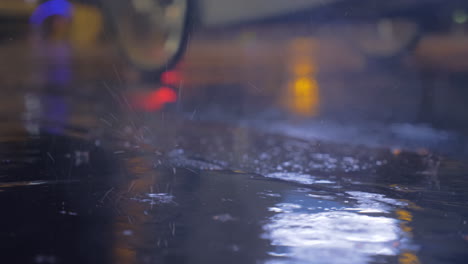 Drizzle-and-puddles-on-the-asphalt-with-lights-reflection