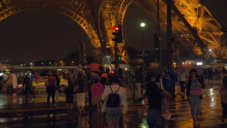 People-on-crosswalk-in-Paris-at-rainy-evening-France
