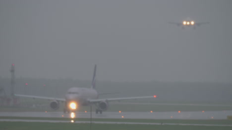 Airport-view-with-parked-and-descending-planes