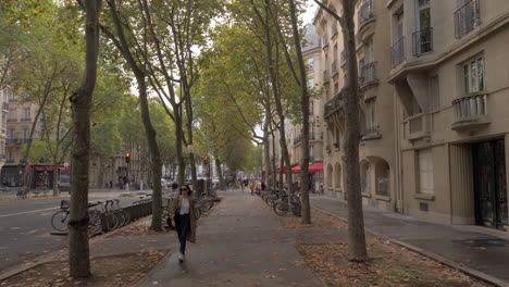 Walking-along-the-street-with-Velib-parking-in-Paris-France