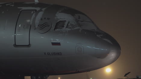 Tug-towing-Aeroflot-A320-airplane-at-night