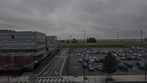 Timelapse-of-car-traffic-on-parking-lot-and-planes-driving-at-airport-Paris
