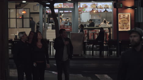 Night-street-in-Alicante-Spain-People-cars-and-fast-food-restaurant