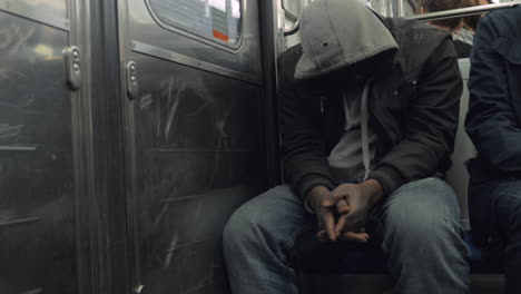 Black-man-in-the-hood-in-subway-train