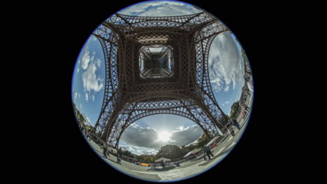 Timelapse-shot-of-people-walking-and-clouds-sailing-View-under-Eiffel-Tower
