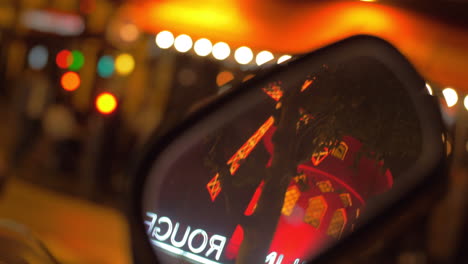 Windmill-of-Moulin-Rouge-reflecting-in-motorbike-mirror-Night-Paris-France