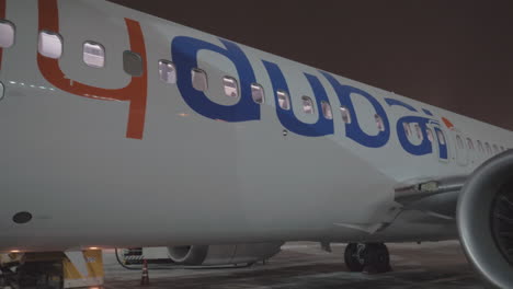 Boarding-Flydubai-aircraft-at-night-Airplane-view-with-air-bridge-and-engines