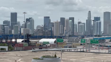 Royal-Caribbean-logo-port-dock-with-Miami-Beach-city-Florida-cityscape-skyscrapers-buildings-in-background-tilt-up-and-down-beautiful-introduction-transportation-vacation-travel-industry