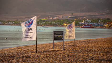 Beach-with-waving-flags-in-Dahab,-Egypt