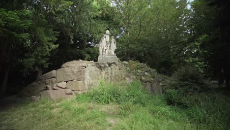 A-orbit-gimbal-shot-of-Hermann-and-Dorothea-statue-in-the-Schlossgarten-of-Karlsruhe