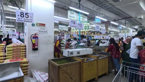 POV-SHOT,-A-customer-inside-the-mall-is-picking-up-cereal-beans,-and-checking-the-price