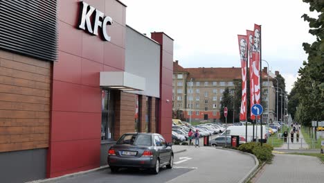 Car-waiting-for-a-burger-to-be-delivered-at-KFC-fast-food-drive-thru-window