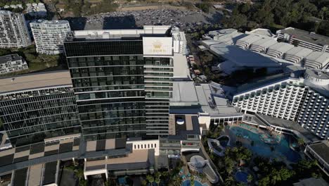 Aerial-orbiting-shot-of-Crown-Casino-Hotel-in-Perth-City-during-sunset-time,-Western-Australia