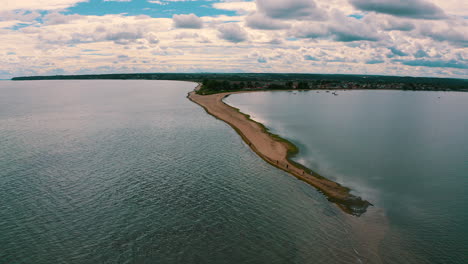 Drone-flying-towards-headland-on-baltic-sea-in-Rewa,-Poland