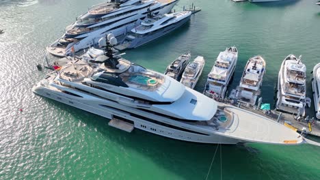 In-the-picturesque-marina-of-Miami,-Florida,-a-luxury-boat-show-displays-a-stunning-array-of-motor-yachts