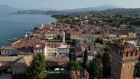 Left-to-right-aerial-pan-shot-of-a-city-near-sea-with-antique-architecture-Lazise-gardasee-verona