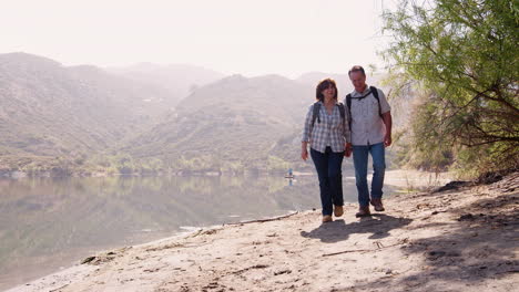 Senior-couple-hiking-by-a-mountain-lake