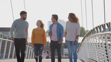 Group-Of-Young-Friends-Walking-Over-City-Bridge-Together